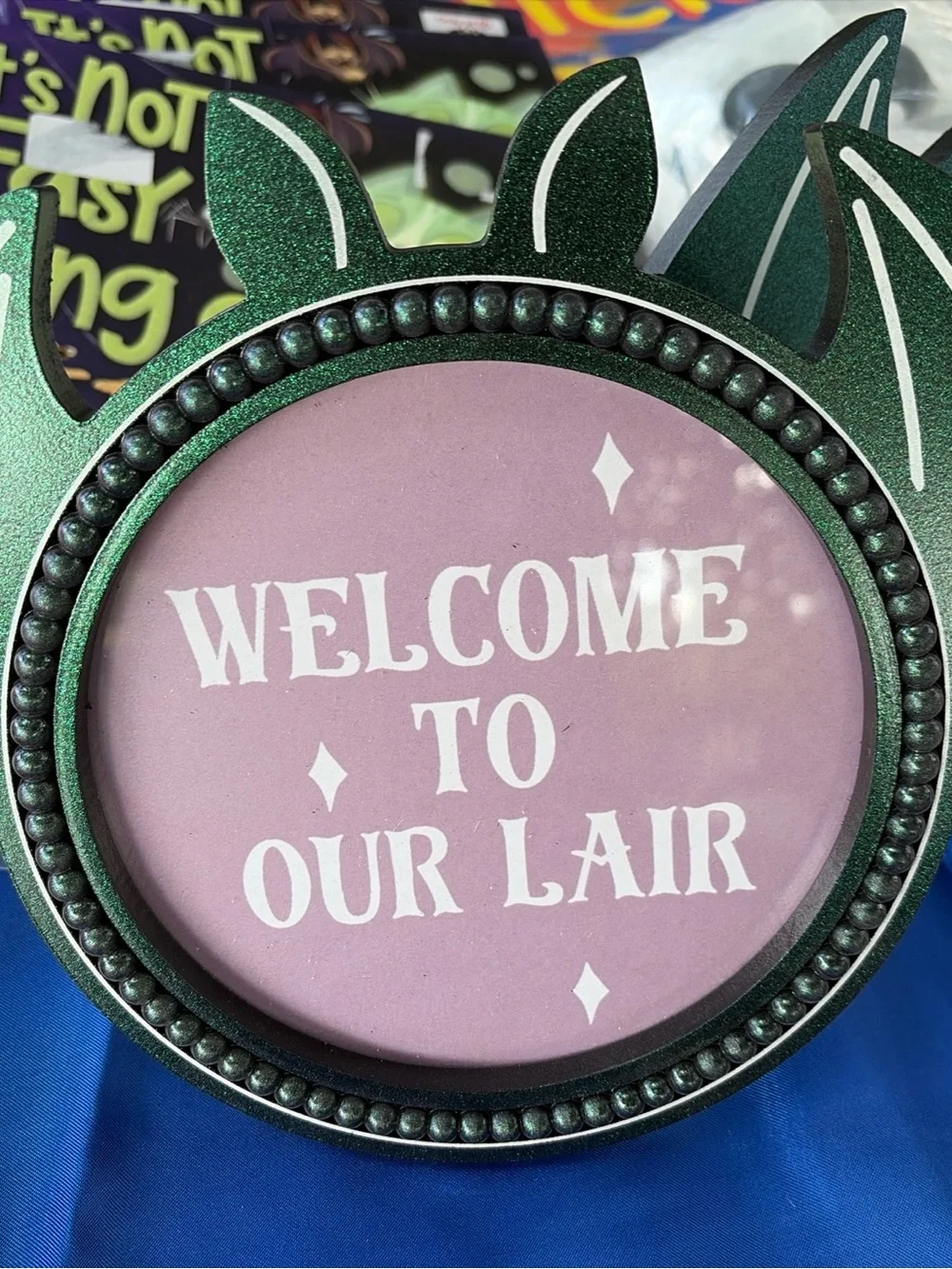 Welcome to Our Lair Decorative Sign - Green Frame, Pink Insert